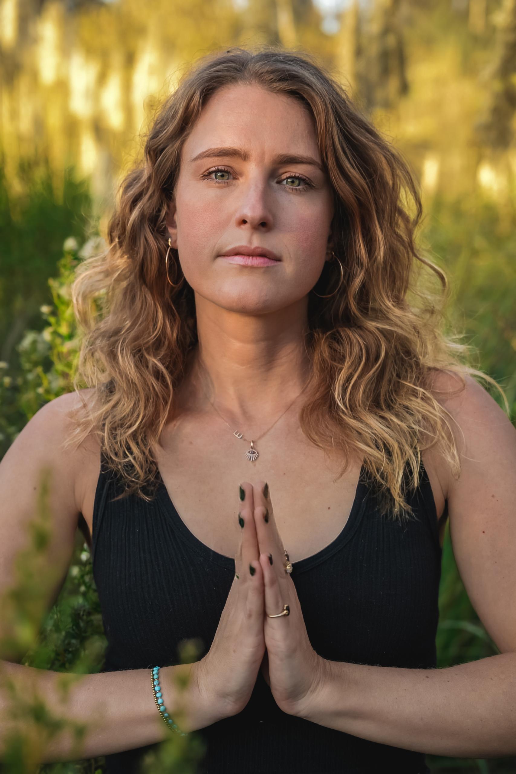 Emily Beliveau smiling in a forest